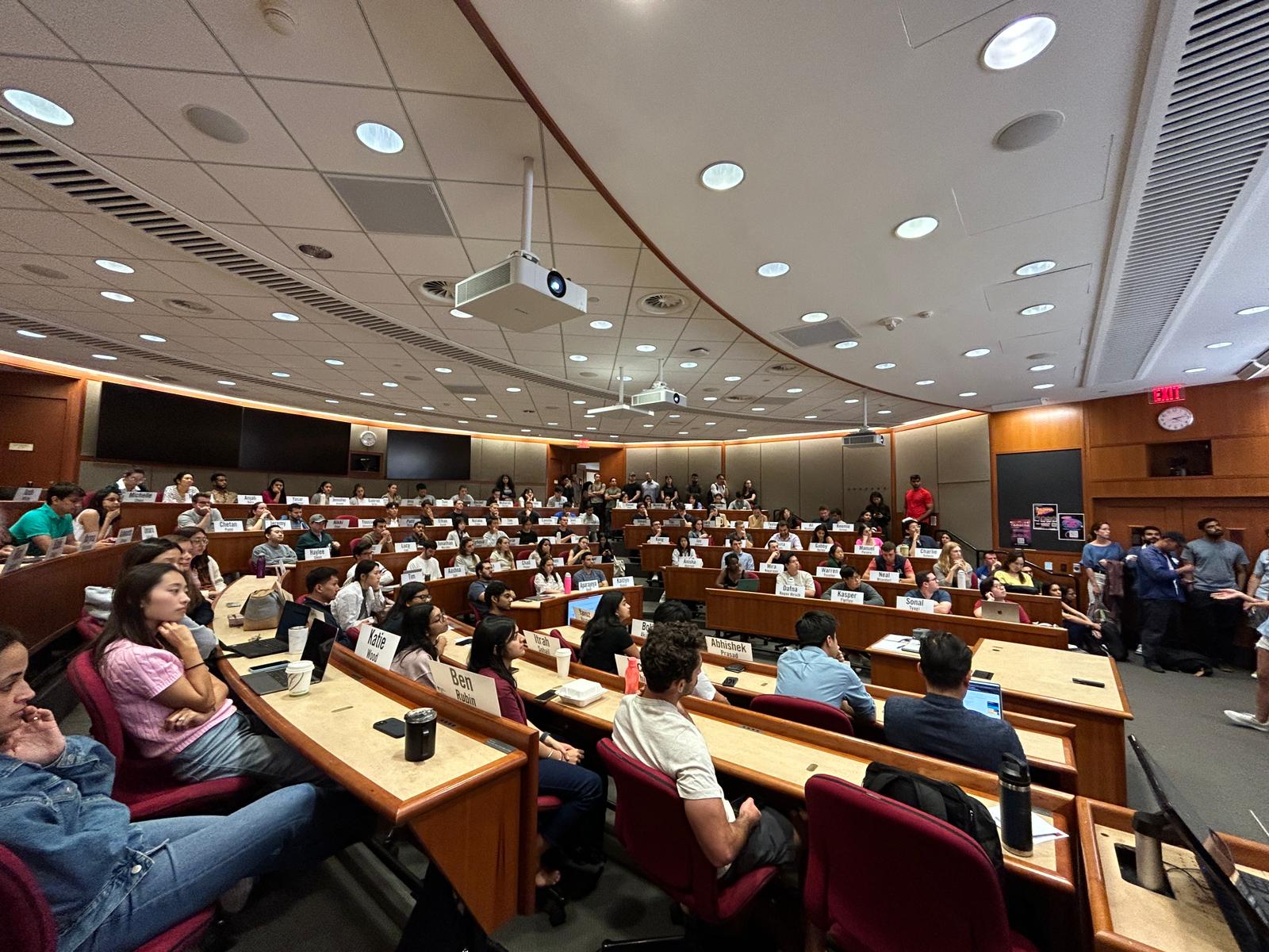 Students raising hands in an HBS classroom session